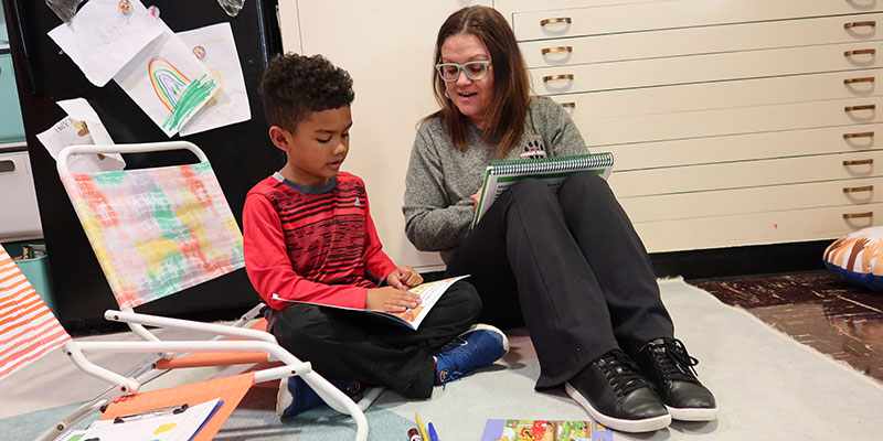 A kid and a professor working together.